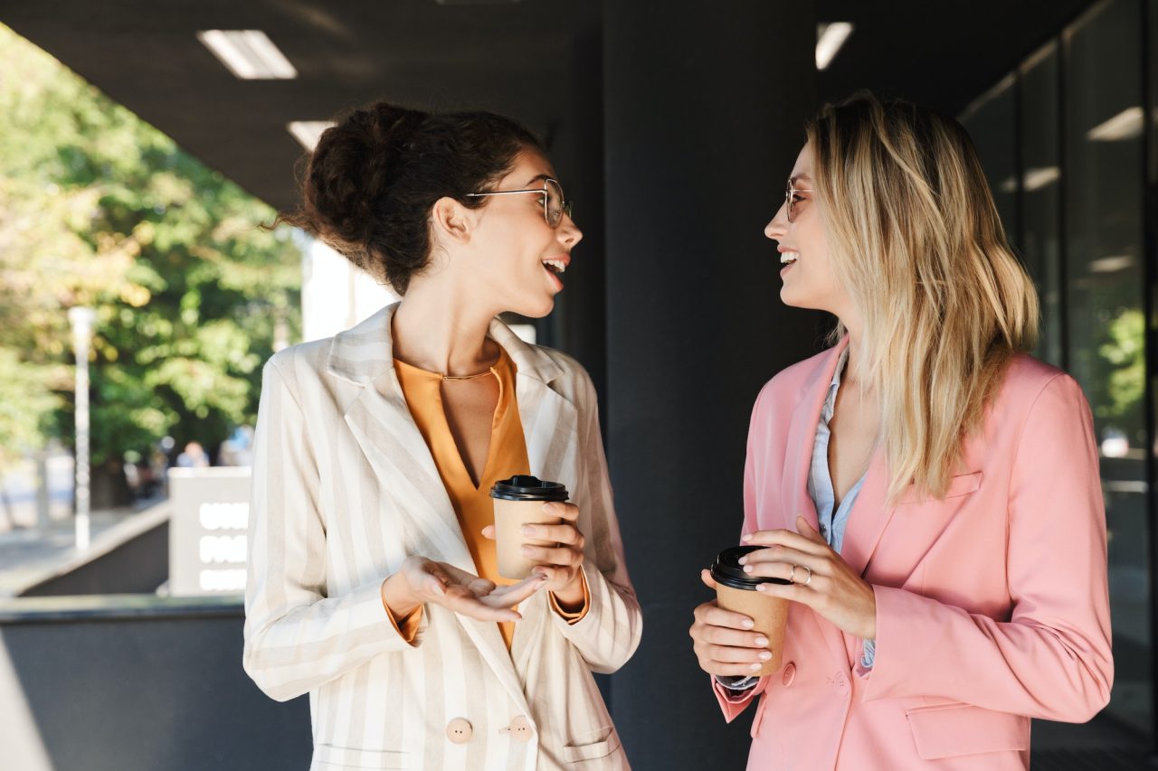 two beautiful young businesswomen walking outdoors • Portfolio